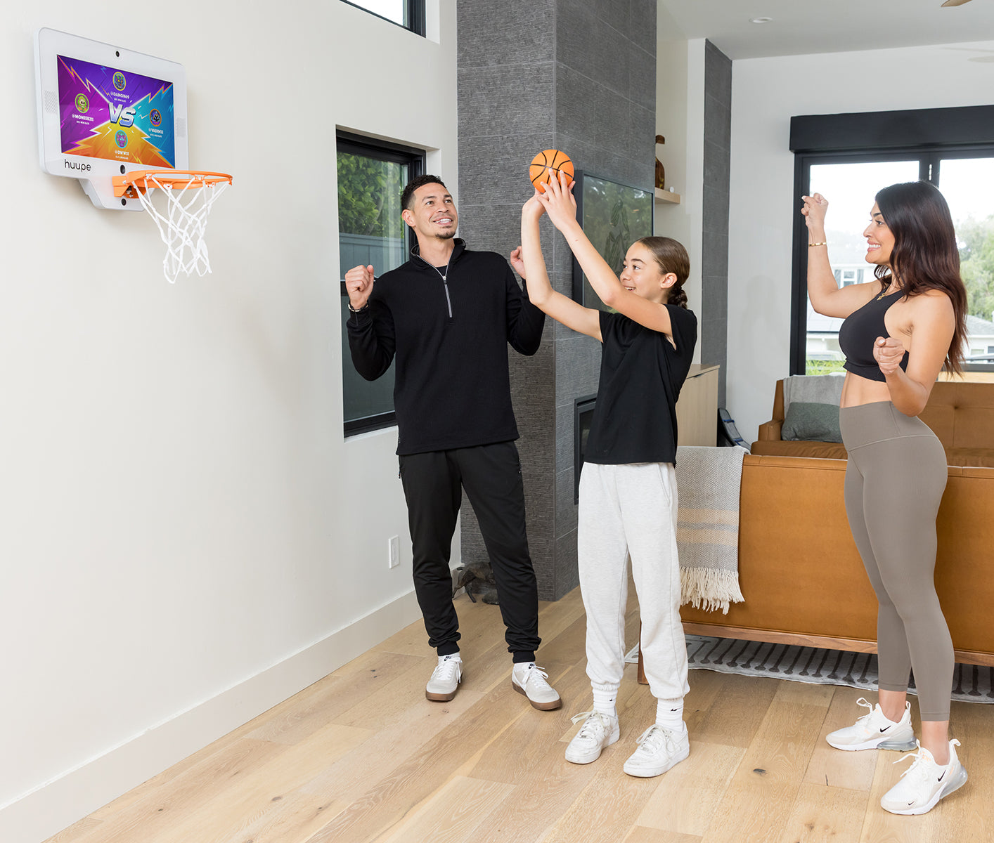 Family playing huupe mini together in the living room